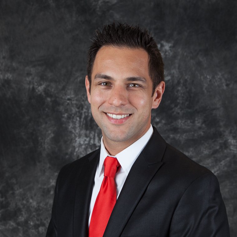 Finance professional headshot of a man in a suit and red tie